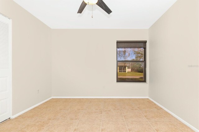 unfurnished room with ceiling fan, baseboards, and light tile patterned flooring