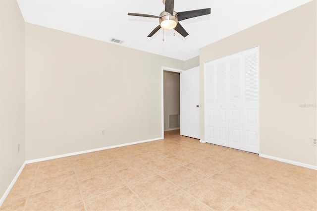 unfurnished bedroom with ceiling fan, light tile patterned floors, visible vents, baseboards, and a closet