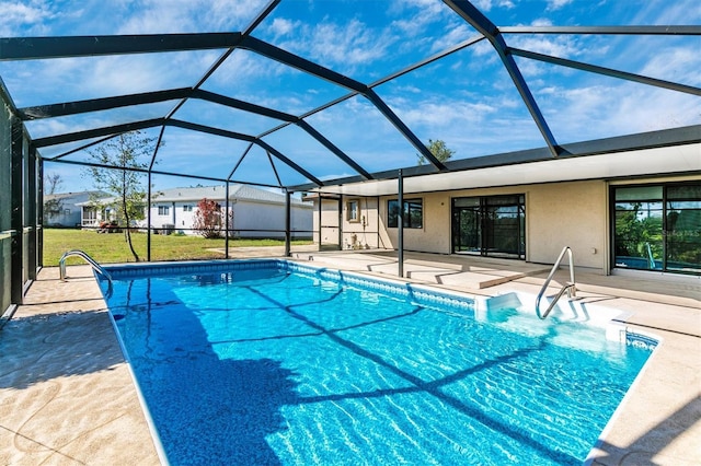 pool featuring a lanai, a patio area, and a yard