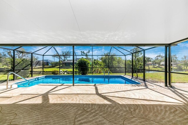 outdoor pool with a patio area and a lanai