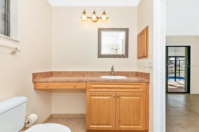 bathroom with vanity, toilet, and tile patterned floors