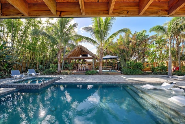 view of swimming pool featuring an in ground hot tub, a gazebo, and a patio area