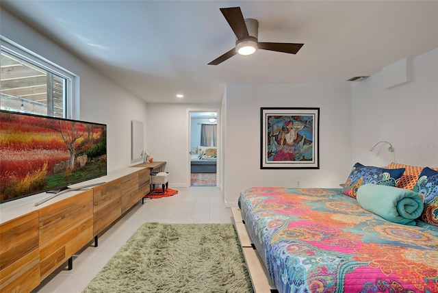 tiled bedroom featuring ensuite bathroom and ceiling fan