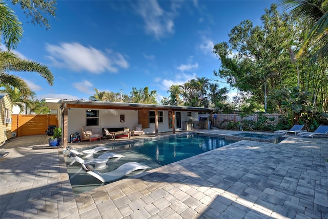 view of pool featuring a patio area, an in ground hot tub, and outdoor lounge area