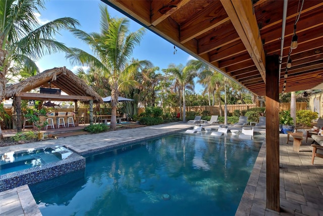 view of pool with an in ground hot tub, an outdoor bar, and a patio area