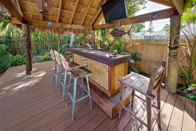 wooden deck featuring exterior bar and a gazebo