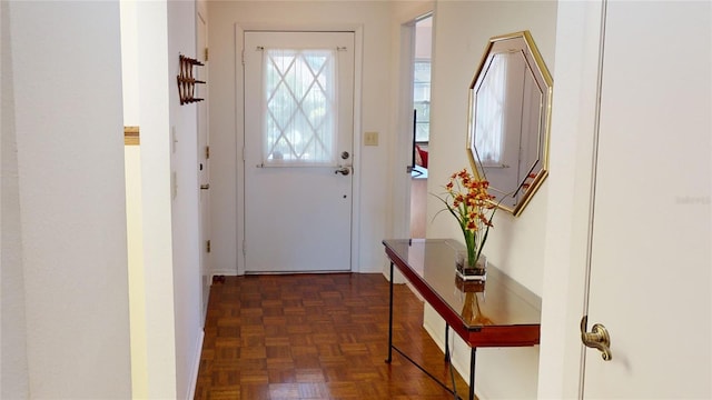 doorway with dark parquet flooring