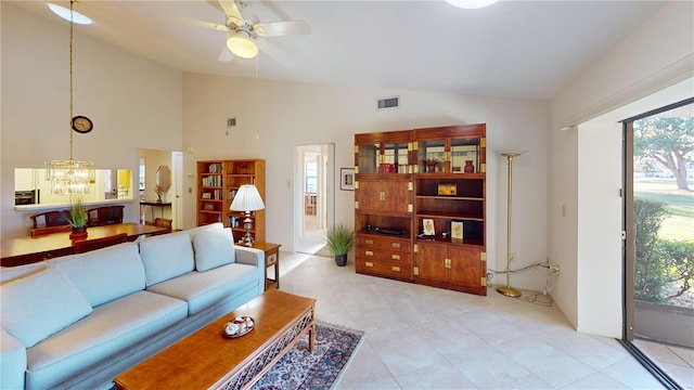 living room featuring ceiling fan with notable chandelier and vaulted ceiling