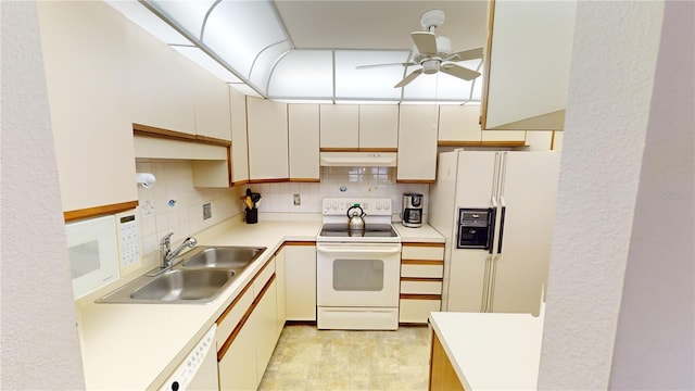 kitchen with sink, white appliances, ceiling fan, and backsplash