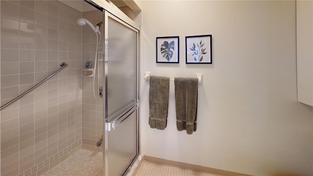 bathroom with tile patterned floors and a shower with shower door