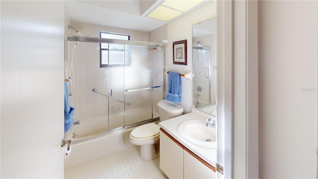 full bathroom with tile patterned flooring, vanity, toilet, and shower / bath combination with glass door