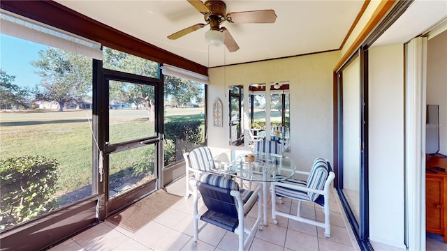 sunroom featuring ceiling fan