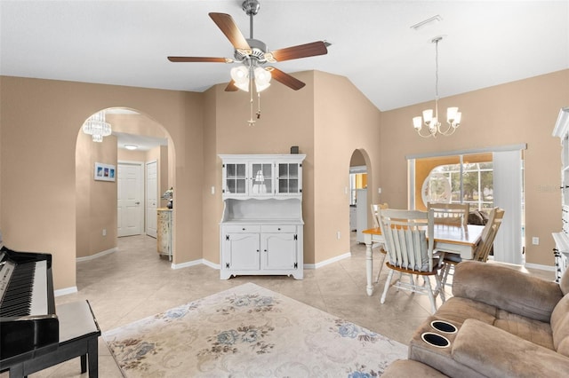 living room featuring light tile patterned floors, ceiling fan with notable chandelier, and high vaulted ceiling