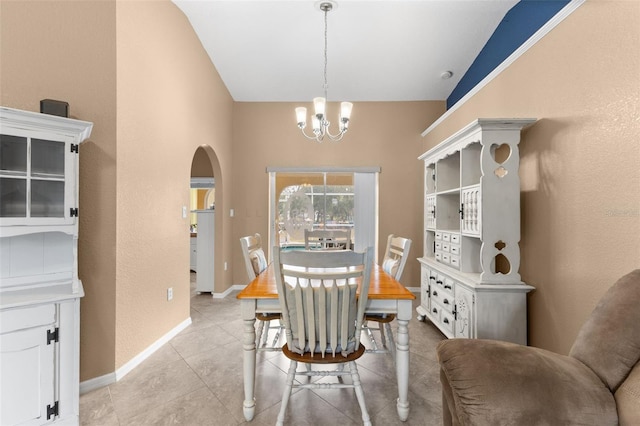 tiled dining space with a chandelier and lofted ceiling