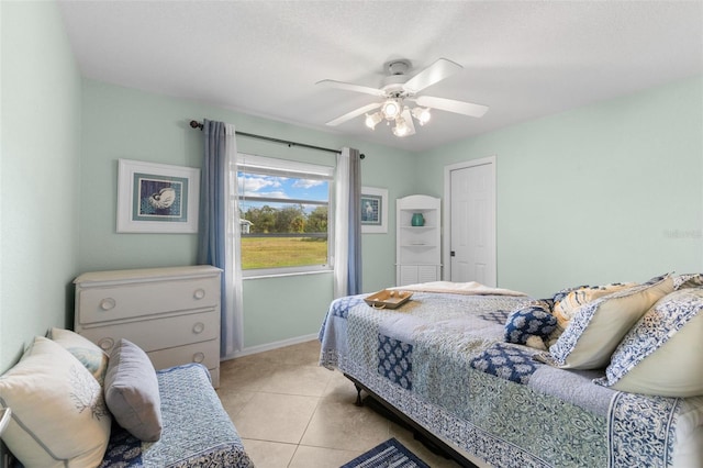 tiled bedroom with ceiling fan