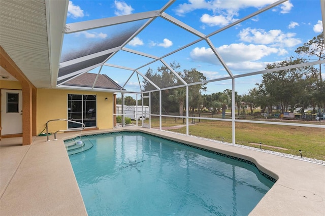 view of pool featuring a lanai, a yard, and a patio