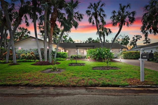 ranch-style house featuring a lawn