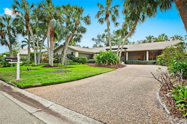 single story home featuring a front yard