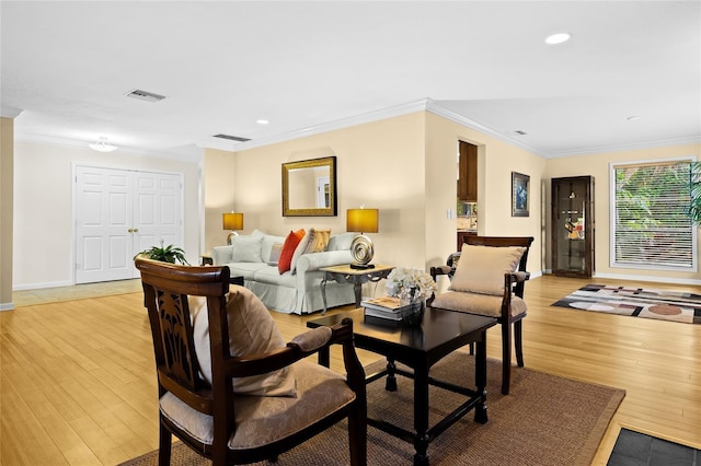 living room with light hardwood / wood-style floors and ornamental molding