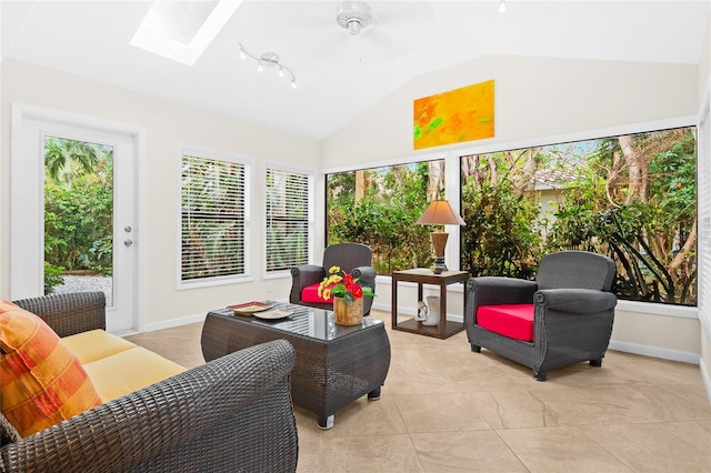 sunroom with ceiling fan and lofted ceiling with skylight