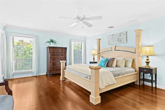 bedroom featuring ornamental molding, ceiling fan, and dark wood-type flooring