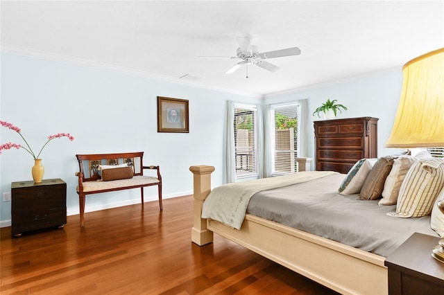 bedroom with ceiling fan, crown molding, and dark hardwood / wood-style floors