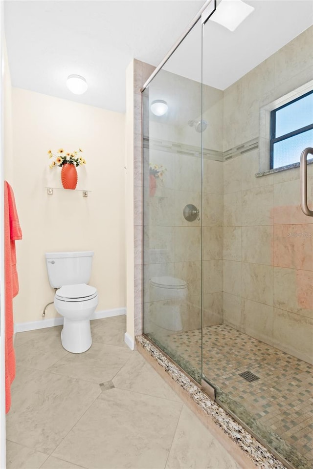 bathroom featuring toilet and walk in shower