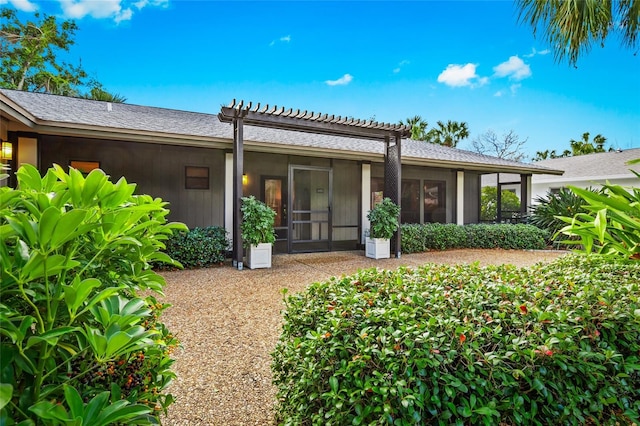 back of property with a sunroom