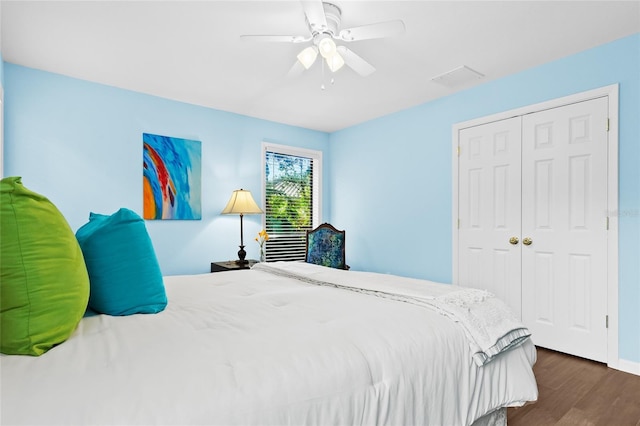 bedroom with ceiling fan, dark hardwood / wood-style flooring, and a closet