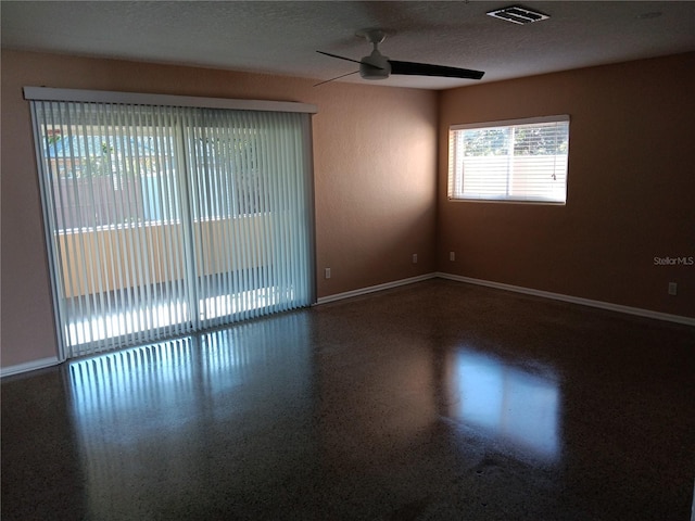 unfurnished room featuring a textured ceiling and ceiling fan