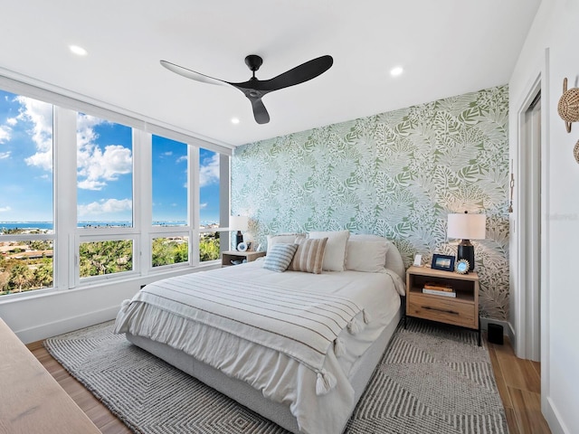 bedroom featuring wood-type flooring and ceiling fan