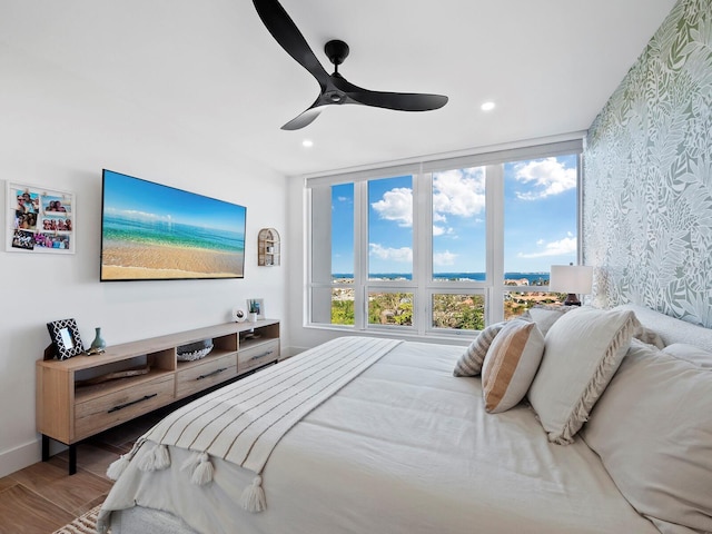 bedroom featuring hardwood / wood-style flooring and ceiling fan