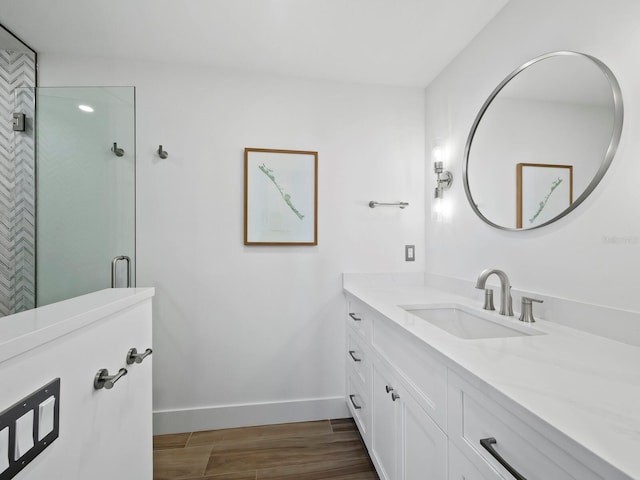 bathroom with a shower with door, vanity, and wood-type flooring