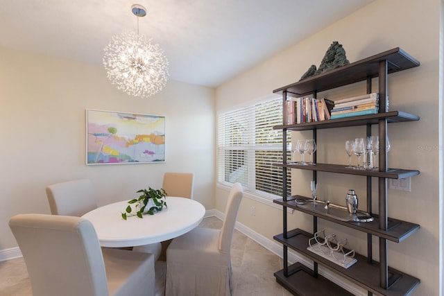 dining space with a notable chandelier and light tile patterned floors