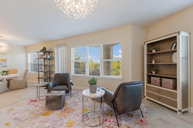 living area featuring a notable chandelier and light tile patterned flooring