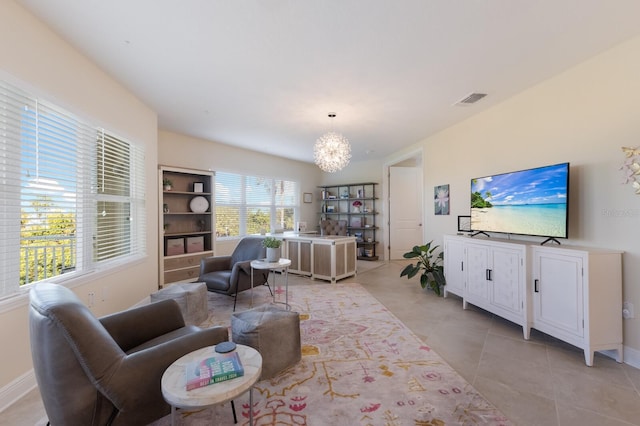 living room featuring light tile patterned floors and a notable chandelier