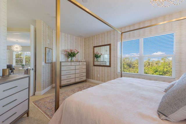 bedroom featuring a chandelier and light colored carpet