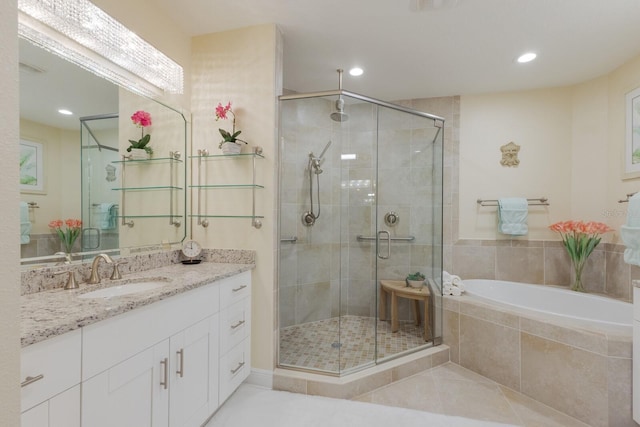 bathroom with tile patterned flooring, vanity, and separate shower and tub