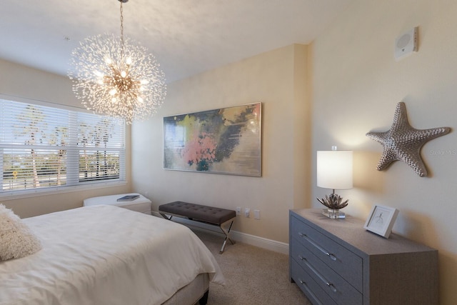 bedroom with light colored carpet and a chandelier