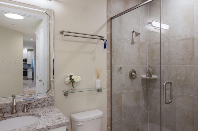 bathroom with tasteful backsplash, a shower with door, vanity, and toilet