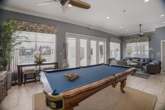 rec room featuring french doors, ceiling fan, crown molding, light tile patterned floors, and billiards