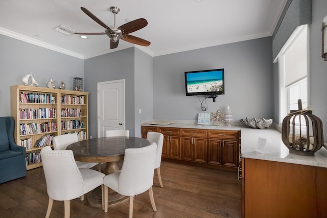 dining space with ceiling fan, dark hardwood / wood-style floors, and ornamental molding