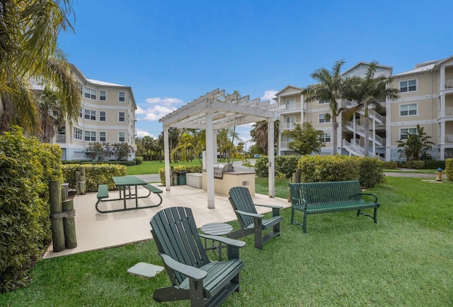 view of home's community featuring a pergola, a lawn, and an outdoor kitchen