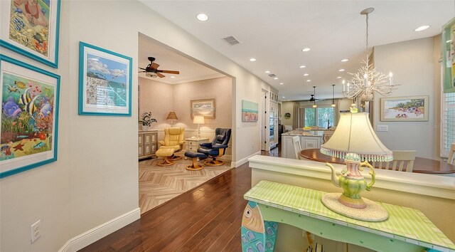 interior space featuring a chandelier, crown molding, and hardwood / wood-style flooring