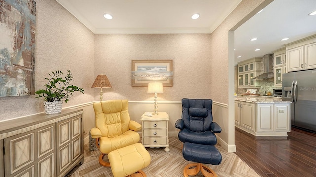 sitting room featuring dark parquet flooring and crown molding