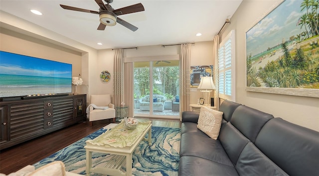 living room with ceiling fan and dark hardwood / wood-style floors