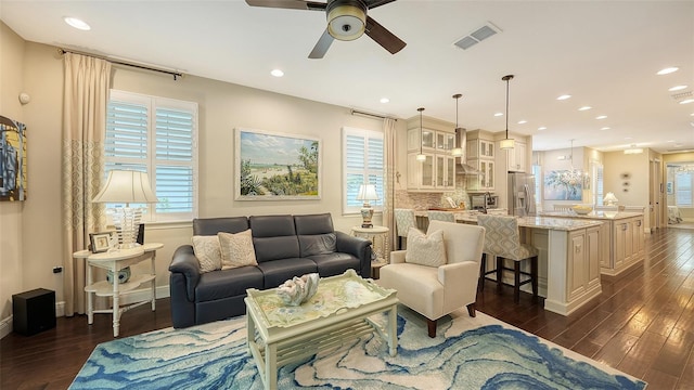 living room with dark wood-type flooring and ceiling fan