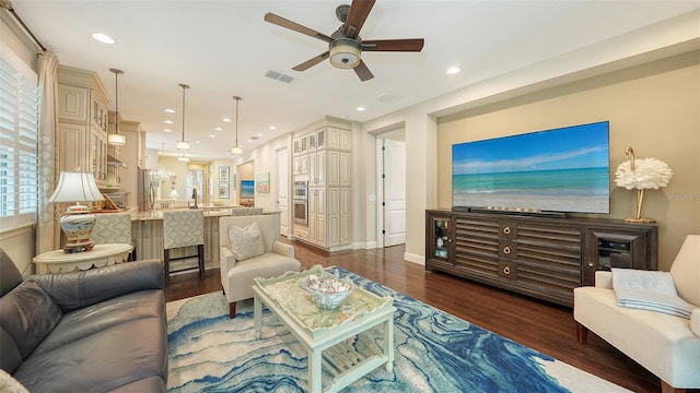 living room with ceiling fan, dark wood-type flooring, and sink