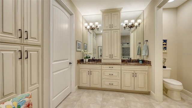 bathroom featuring toilet, vanity, and tile patterned flooring