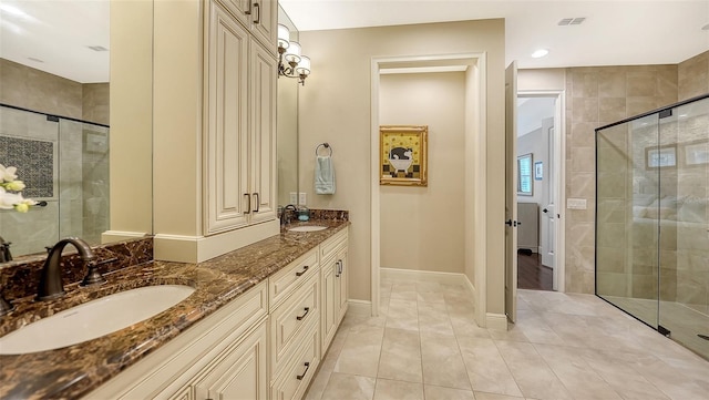 bathroom featuring an enclosed shower, vanity, and tile patterned flooring